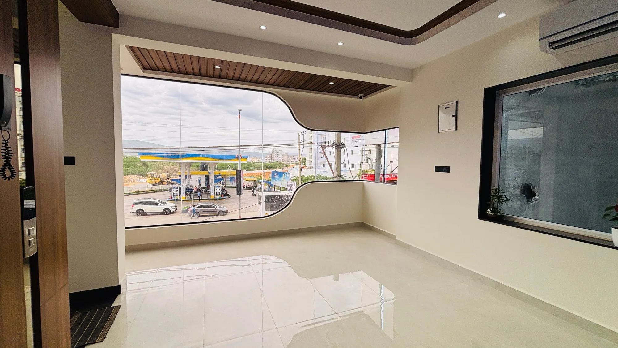 Lobby of Aakarsh Inn with a large curved window onto the street