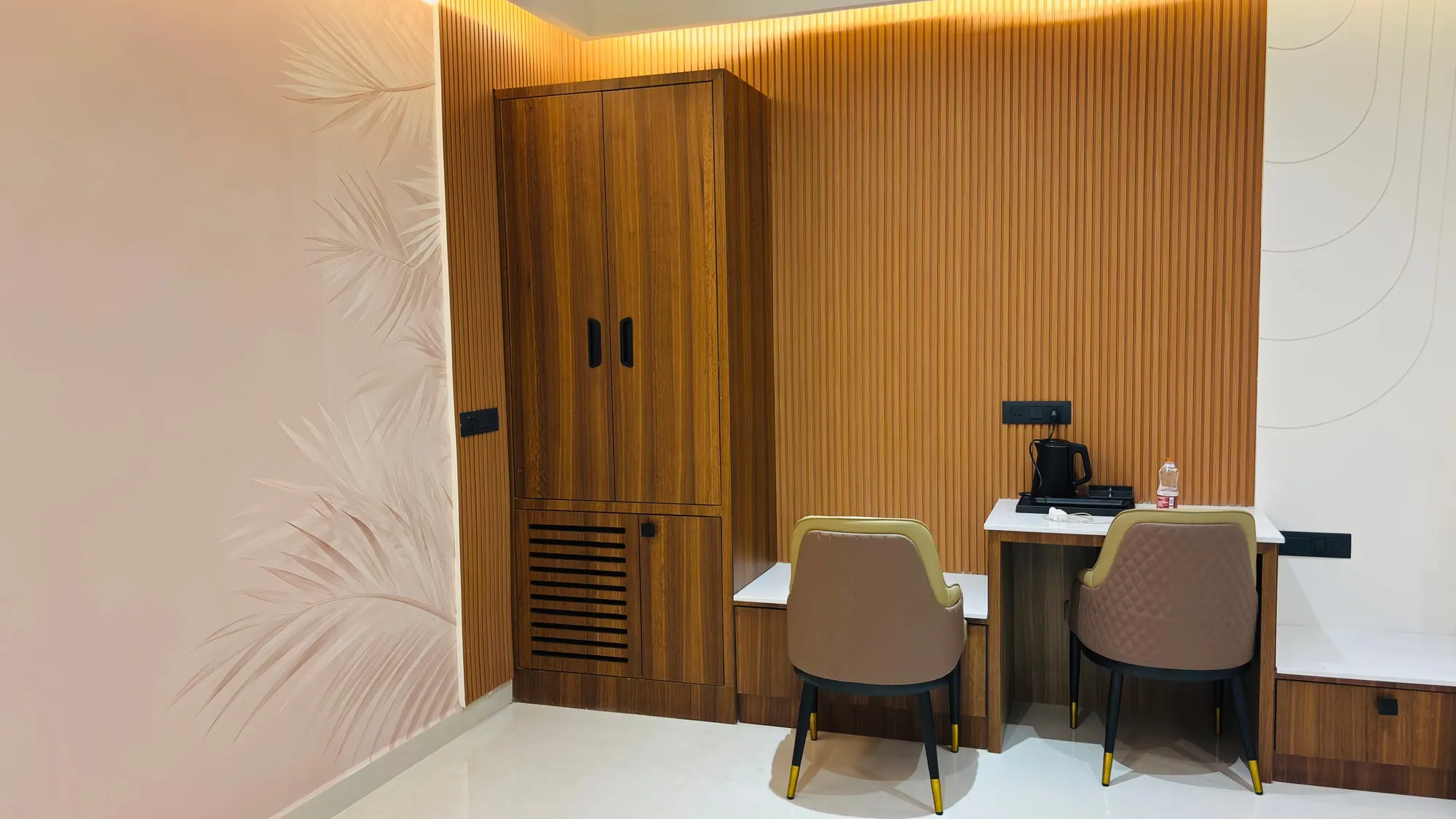 Two olive armchairs and a low table in the Suite Room