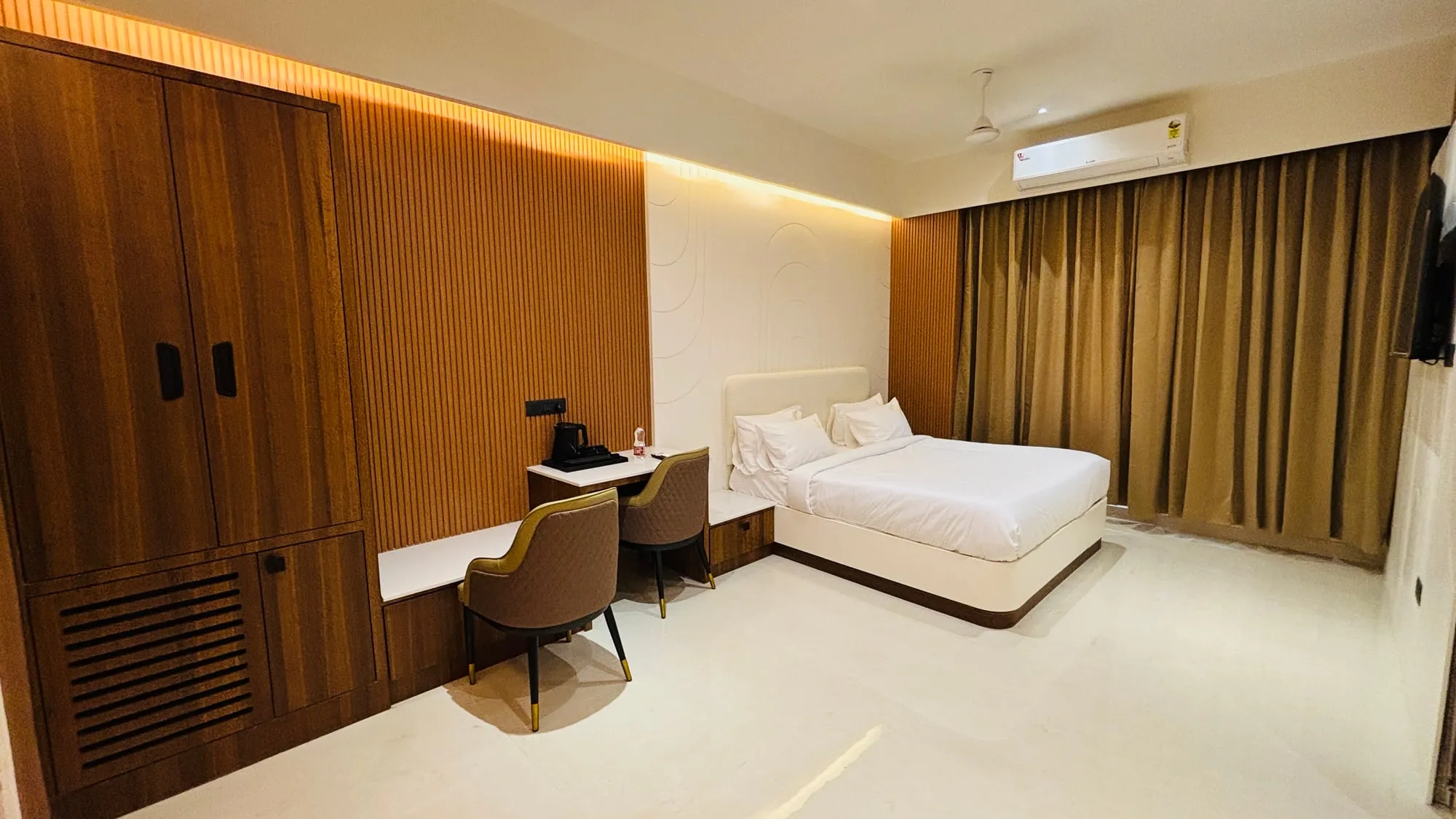 Suite Room seen from the door, with the sitting corner beyond the bed